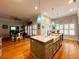 Spacious kitchen featuring custom cabinets, a central island, granite countertops, and modern lighting at 70 Beachwalker Ct., Georgetown, SC 29440