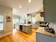 Well-lit kitchen boasts a spacious island, stainless steel appliances, granite countertops, and stylish pendant lighting at 70 Beachwalker Ct., Georgetown, SC 29440