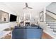 Inviting living room with a fireplace, large sectional sofa, and staircase access, perfect for entertaining guests at 70 Beachwalker Ct., Georgetown, SC 29440