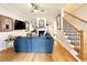 Spacious living room with hardwood floors, a fireplace, and a comfortable blue sofa, creating a cozy atmosphere at 70 Beachwalker Ct., Georgetown, SC 29440