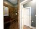 Tile shower with a bench and built-in shelves, featuring a window with shutter and a door at 70 Beachwalker Ct., Georgetown, SC 29440