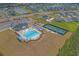 Aerial view of community amenities, including a pool, playground, parking, and pickleball court at 753 Enchantment Loop, Myrtle Beach, SC 29588