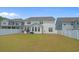 View of back of home, featuring a large grassy lawn and privacy fence, perfect for families with and pets at 753 Enchantment Loop, Myrtle Beach, SC 29588