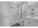 Bright bathroom featuring white vanity, framed mirror, a glass-enclosed shower, and a window for natural light at 753 Enchantment Loop, Myrtle Beach, SC 29588