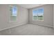 Bright bedroom with neutral walls, carpet flooring, and two windows providing ample natural light at 753 Enchantment Loop, Myrtle Beach, SC 29588