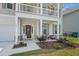 Charming front porch with decorative accents, landscaping, and a welcoming entrance on a sunny day at 753 Enchantment Loop, Myrtle Beach, SC 29588