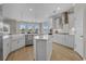 Bright, open kitchen featuring white cabinetry, stainless steel appliances, and hardwood floors at 753 Enchantment Loop, Myrtle Beach, SC 29588