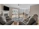 Open concept living room with hardwood floors, fireplace, and access to the kitchen and sunroom at 753 Enchantment Loop, Myrtle Beach, SC 29588