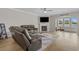 Comfortable living room with hardwood floors, fireplace, TV, and views to the sunroom at 753 Enchantment Loop, Myrtle Beach, SC 29588