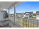 Inviting porch with a hanging chair, views of the neighborhood, and white railings and columns at 753 Enchantment Loop, Myrtle Beach, SC 29588