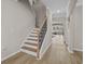 Bright entryway with hardwood floors and stairs featuring wood treads and decorative iron spindles at 753 Enchantment Loop, Myrtle Beach, SC 29588