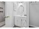 Bright bathroom featuring a large vanity, a round mirror, and updated hardware at 800 9Th Ave. S # E-4, North Myrtle Beach, SC 29582
