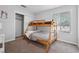 Bedroom with a window, carpet flooring and a wooden bunk bed at 800 9Th Ave. S # E-4, North Myrtle Beach, SC 29582