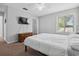 Comfortable bedroom with large TV, closet, and a window providing natural light at 800 9Th Ave. S # E-4, North Myrtle Beach, SC 29582