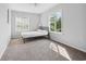 Bright bedroom with two windows, a ceiling fan, and neutral carpeting at 800 9Th Ave. S # E-4, North Myrtle Beach, SC 29582