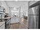 Open floor plan with kitchen and dining area featuring stainless steel appliances and wood flooring at 800 9Th Ave. S # E-4, North Myrtle Beach, SC 29582