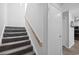 Carpeted stairway with white walls and wood railing at 800 9Th Ave. S # E-4, North Myrtle Beach, SC 29582