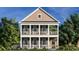 Two-story home with double porches, white railings, shutters, and lush landscaping for outdoor enjoyment at 8163 Wood Pass Lane, Myrtle Beach, SC 29572