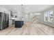 Open floor plan with wood floors seamlessly connects the living room, kitchen, and staircase at 8163 Wood Pass Lane, Myrtle Beach, SC 29572