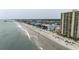 Aerial view of oceanfront condo building, with other resort hotels, beach and swimming pool at 912 N Waccamaw Dr. # 904, Garden City Beach, SC 29576