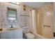 A clean bathroom with tub-shower combination and vanity with well-lit mirror at 912 N Waccamaw Dr. # 904, Garden City Beach, SC 29576