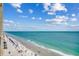 Breathtaking view of the sandy beach and oceanfront from a high-rise condo with clear blue skies and fluffy white clouds at 912 N Waccamaw Dr. # 904, Garden City Beach, SC 29576