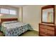 A cozy bedroom with a queen bed, wooden dresser, and a view of natural light filtering through the blinds at 912 N Waccamaw Dr. # 904, Garden City Beach, SC 29576