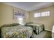 A well-lit bedroom featuring two twin beds with floral patterned bedding and a window at 912 N Waccamaw Dr. # 904, Garden City Beach, SC 29576