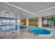 Indoor pool area with hot tub, tables, and an ocean view at 912 N Waccamaw Dr. # 904, Garden City Beach, SC 29576