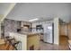 Well-lit kitchen with a breakfast bar, updated appliances, and tile flooring at 912 N Waccamaw Dr. # 904, Garden City Beach, SC 29576