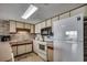 Bright kitchen with white appliances and stone backsplash at 912 N Waccamaw Dr. # 904, Garden City Beach, SC 29576