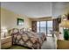 A comfortable main bedroom with a king-size bed, balcony access, and a soothing ocean view to wake up to at 912 N Waccamaw Dr. # 904, Garden City Beach, SC 29576