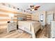 Cozy bedroom featuring stylish coastal decor, a ceiling fan, and wooden-look tile flooring at 9820 Queensway Blvd. # 502, Myrtle Beach, SC 29572