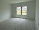 Bright bedroom with a large window and fresh natural light, new construction at 1021 Jase Dr., Longs, SC 29568