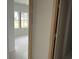Light-filled room with window overlooking a yard and an adjacent doorframe at 1021 Jase Dr., Longs, SC 29568