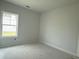 Bright room with a window showcasing natural light and clean, neutral finishes awaiting personal touches at 1021 Jase Dr., Longs, SC 29568