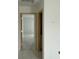 Hallway with an open doorway showcasing natural wood trim and access to additional rooms at 1021 Jase Dr., Longs, SC 29568