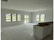 Open living room featuring large windows and sliding glass doors for an airy space, new construction at 1021 Jase Dr., Longs, SC 29568