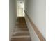 Staircase with natural wood handrail leading to the next level of this home at 1021 Jase Dr., Longs, SC 29568