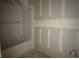 A bathroom with a tub and drywall, ready to be transformed into a relaxing space at 1045 Jase Dr., Longs, SC 29568