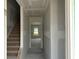 Bright hallway with stairs, showcasing the home's layout and potential for customization at 1045 Jase Dr., Longs, SC 29568