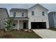 Charming two-story home with white siding, manicured lawn, attached garage, and a welcoming front porch at 1050 Laconic Dr., Myrtle Beach, SC 29588