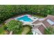 Aerial view of community pool surrounded by lush trees and seating areas at 106 Cypress Creek Dr., Murrells Inlet, SC 29576