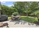 Landscaped backyard featuring mature trees, patio furniture, and a well-manicured lawn at 106 Cypress Creek Dr., Murrells Inlet, SC 29576