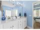 Bathroom features a double sink vanity with white cabinets and a large mirror with light fixtures at 106 Cypress Creek Dr., Murrells Inlet, SC 29576