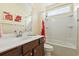 Bathroom with a single vanity, framed mirror, and a shower-tub combination with a bright shower curtain at 106 Cypress Creek Dr., Murrells Inlet, SC 29576