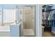 Bathroom showing a tiled shower with a glass door, a bathtub, and an adjacent walk-in closet at 106 Cypress Creek Dr., Murrells Inlet, SC 29576