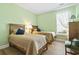 Comfortable bedroom featuring two twin beds, wood flooring, and a bright window at 106 Cypress Creek Dr., Murrells Inlet, SC 29576