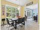 Bright dining room featuring a large window, modern light fixtures, and a view of the backyard at 106 Cypress Creek Dr., Murrells Inlet, SC 29576