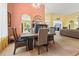 The dining room is complemented by orange and yellow walls and flows to the living room and patio at 106 Cypress Creek Dr., Murrells Inlet, SC 29576